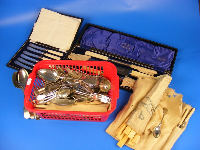 A cased carving set together with another case of knives and a large assortment of cutlery