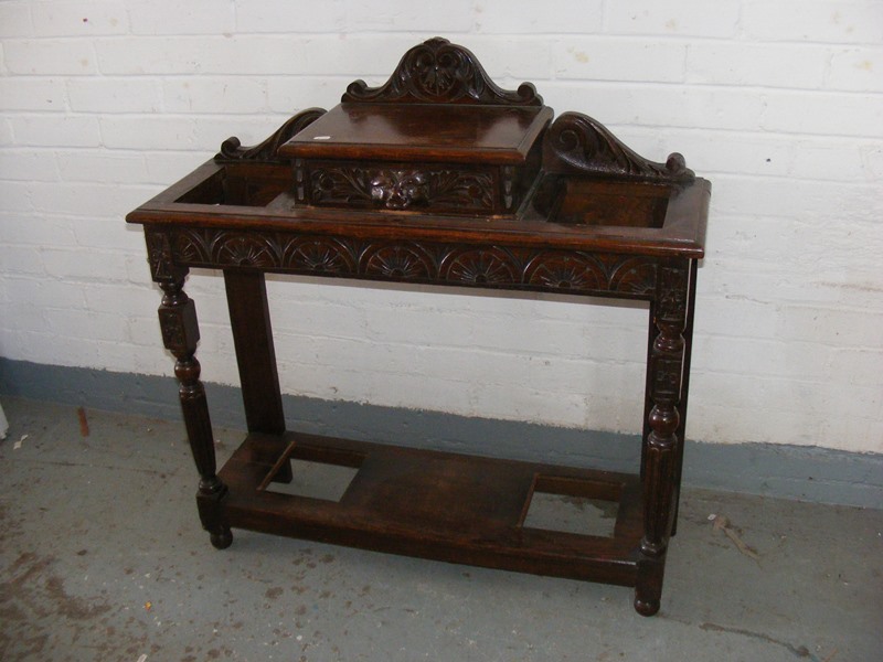 An oak carved antique hall table/umbrella stand