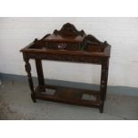 An oak carved antique hall table/umbrella stand