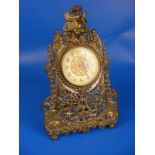 A brass reproduction mantle clock with fold out stand