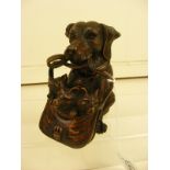 A carved wooden dog holding basket of pups lidded pot