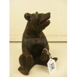 A black forest style carved bear lidded pot