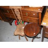 A carved high back stool together with a wine table