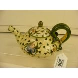 A cantagalli decorative teapot with historic repair to lid