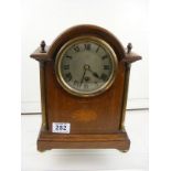 An Edwardian mahogany and line inlaid mantle clock