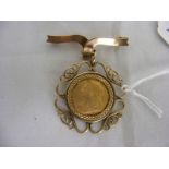 An 1897 half sovereign in 9ct gold brooch mount