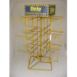 A Dinky four sided enamel shop display rack - 25 inches high,