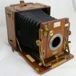 A wood and brass vintage folding camera made by Sanderson of London