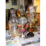 A selection of five antique and later oil lamps