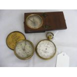 A brass cased pocket barometer by Callachan and Co together with two pocket compasses one in wooden