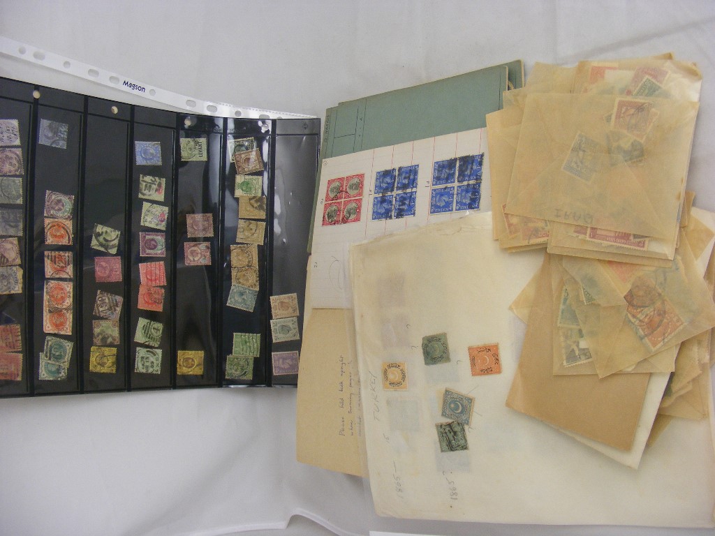 A large quantity of loose world stamps, some in approval booklets,