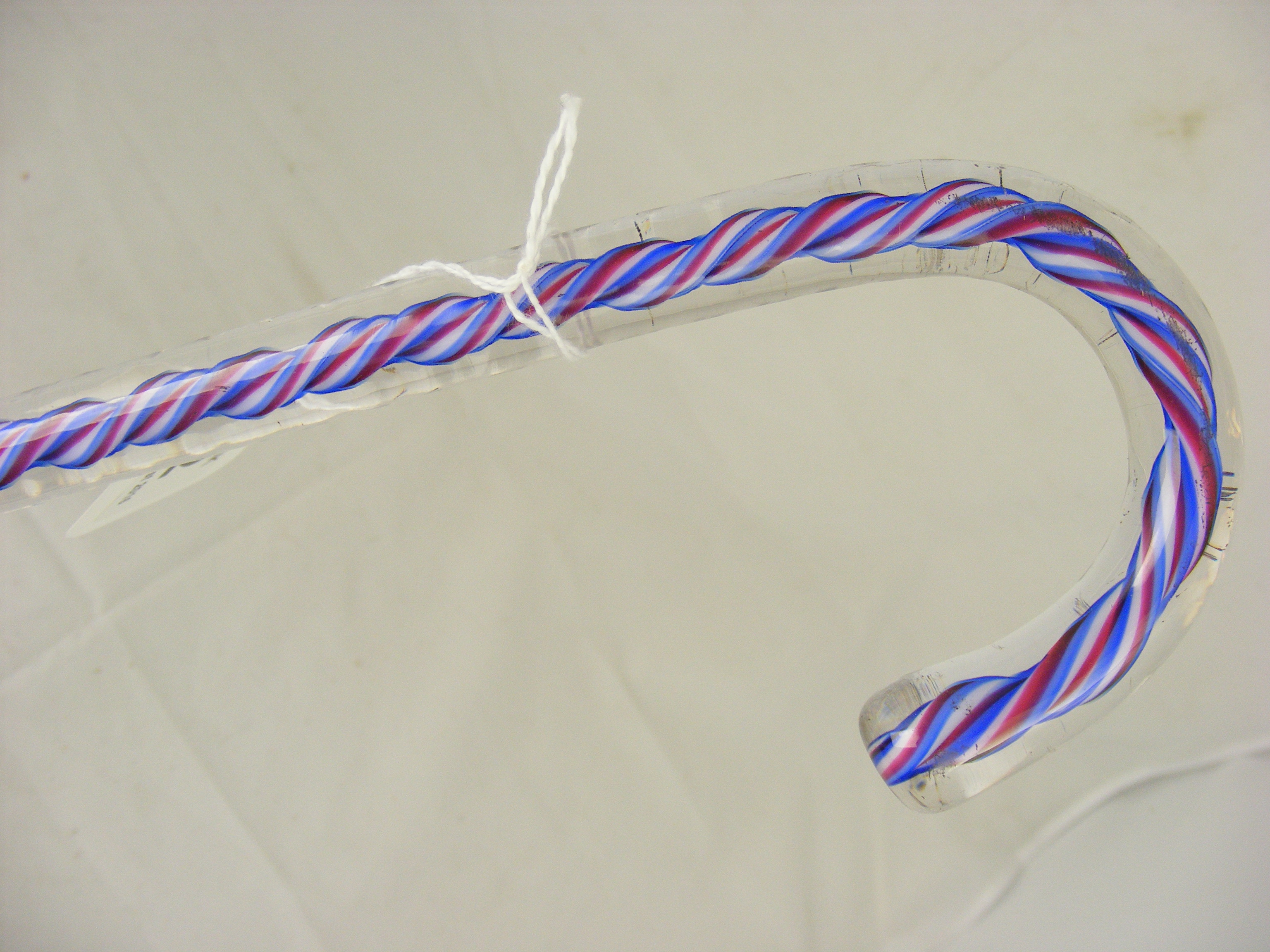 A Glass frigger walking cane with internal Red, White and Blue twist.