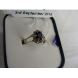 18ct white gold ring set with central sapphire and diamond chips