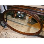 An Antique bevel edge mahogany framed wall mirror