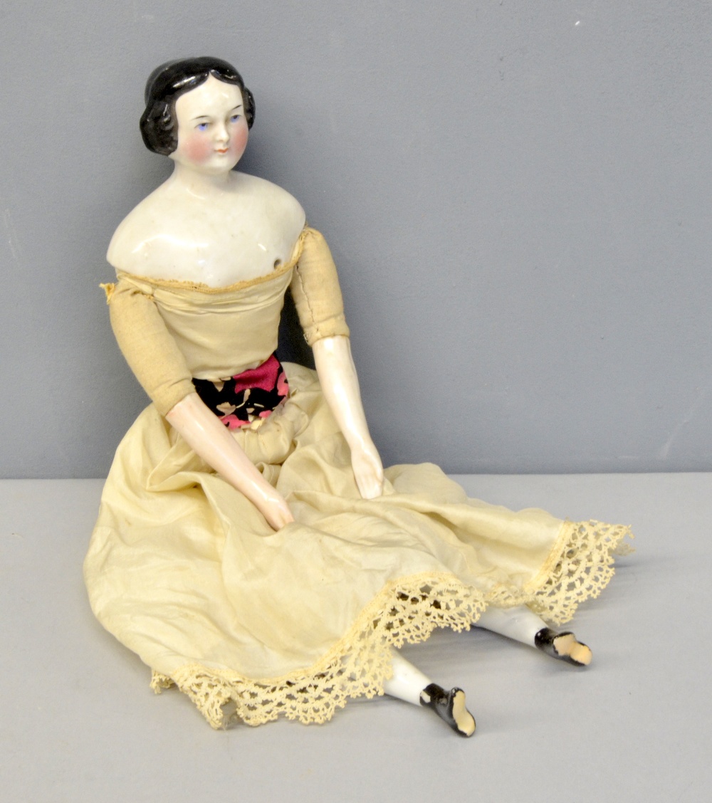 19th century doll with porcelain head, shoulders, arms and legs, with straw filled body in white