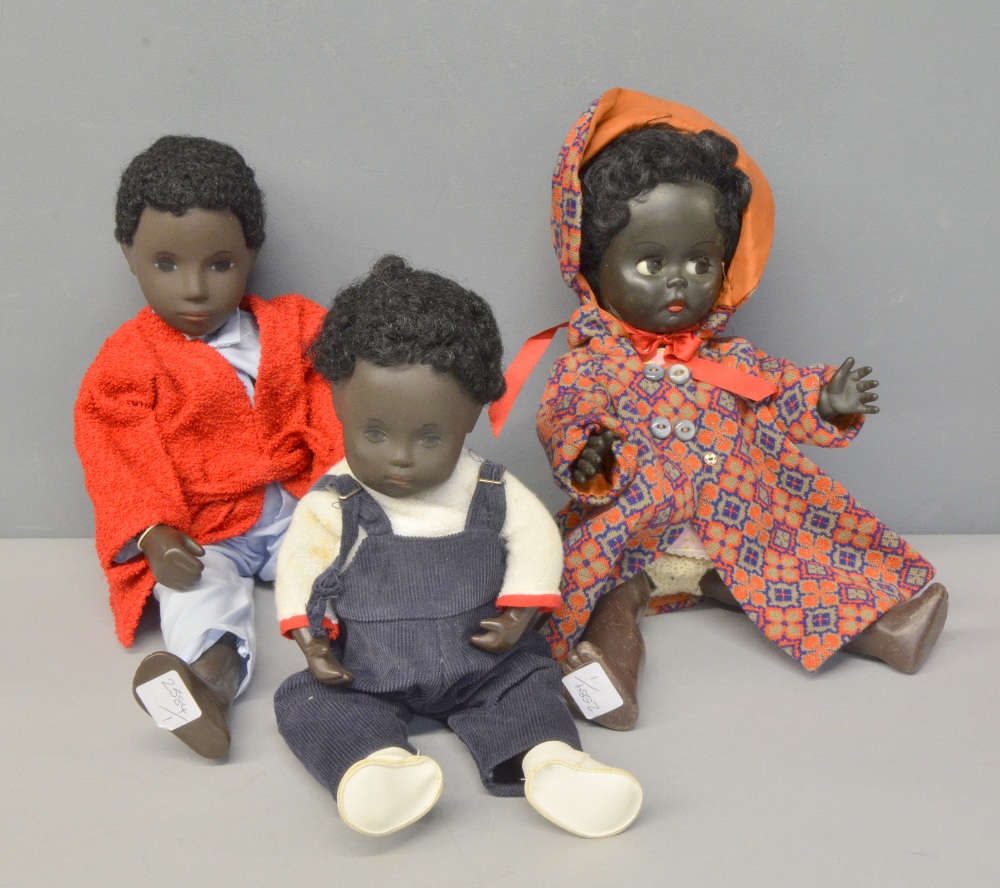 Black 'Sasha' doll, male with original tag and dress black baby doll and 1960's black rubber doll,