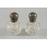 Two cut glass scent bottles, the silver tops with  Art Nouveau chased decoration, Sheffield 1902/4