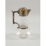 Early 20th Century claret jug, with Aesthetic style decoration, the glass engraved with flowering