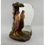 A Continental figural mirror group, circa 1900, depicting a young girl draped in a robe looking at