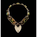 Gold and peridot bracelet, composed of openwork plaques in the Arts and Crafts manner, padlock