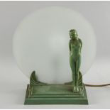 Art Deco lamp, the painted metal base with a nude figure in front of a frosted glass,  Height 33cm