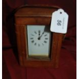 Early 20thC brass carriage clock in a leather case probably French.