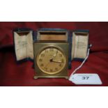 Edwardian brass travel clock with illuminated hands swiss made in a blue leather case for Reid &