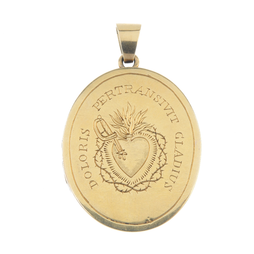 An oval locket. Both sides with a central engraved picture of a heart pierced by a dagger with
