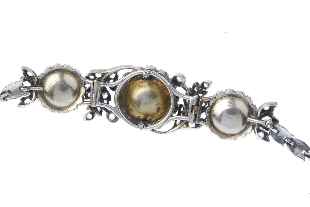 An early 20th century paste bracelet. Designed as three red paste cabochons with colourless paste - Image 2 of 3