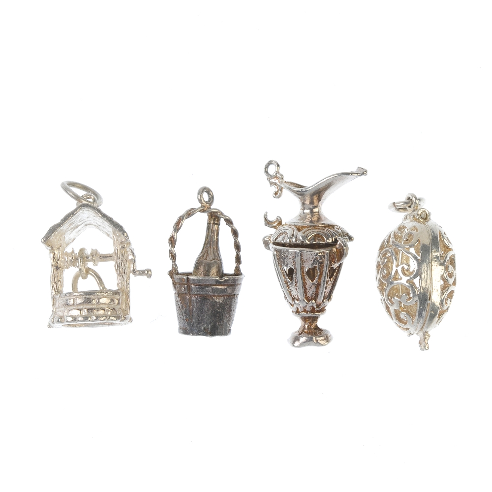 A selection of seventy-six assorted charms. To include a Holy Bible, opening to reveal pages