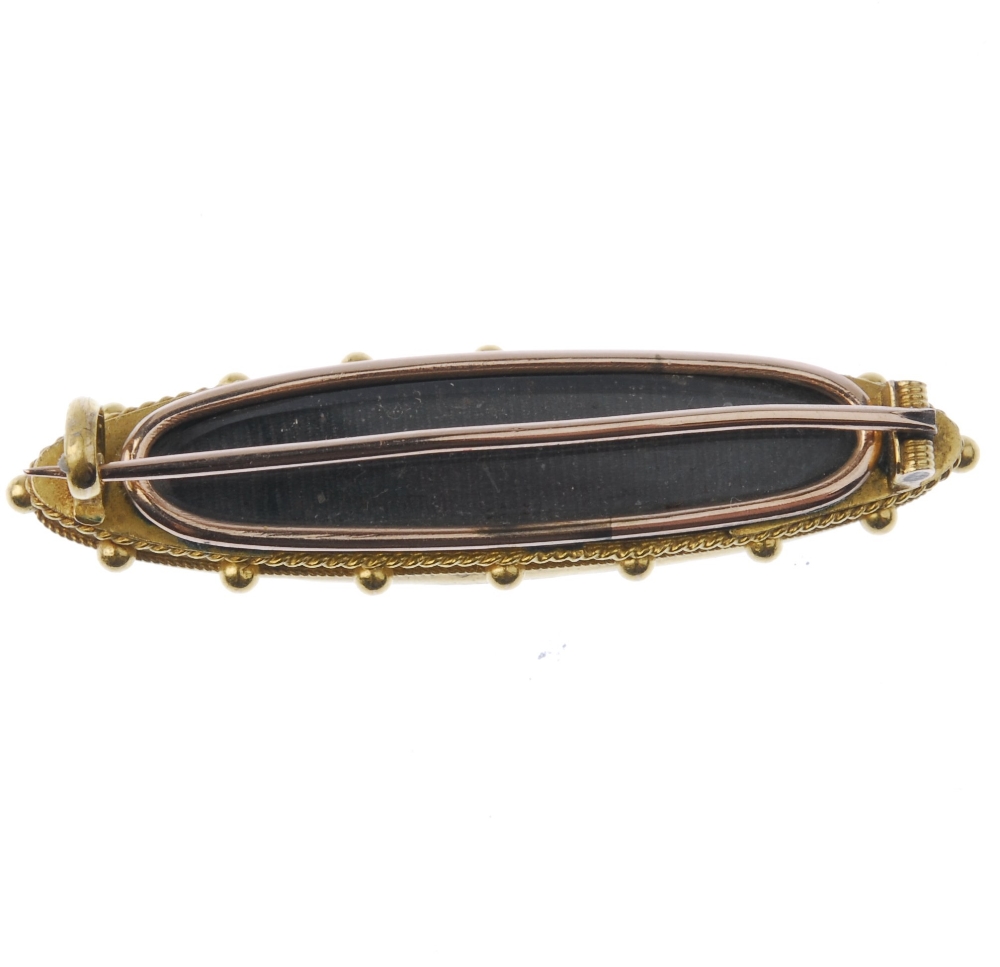 A late 19th century gold memorial brooch. Designed as a marquise-shape onyx set to the central - Image 3 of 3