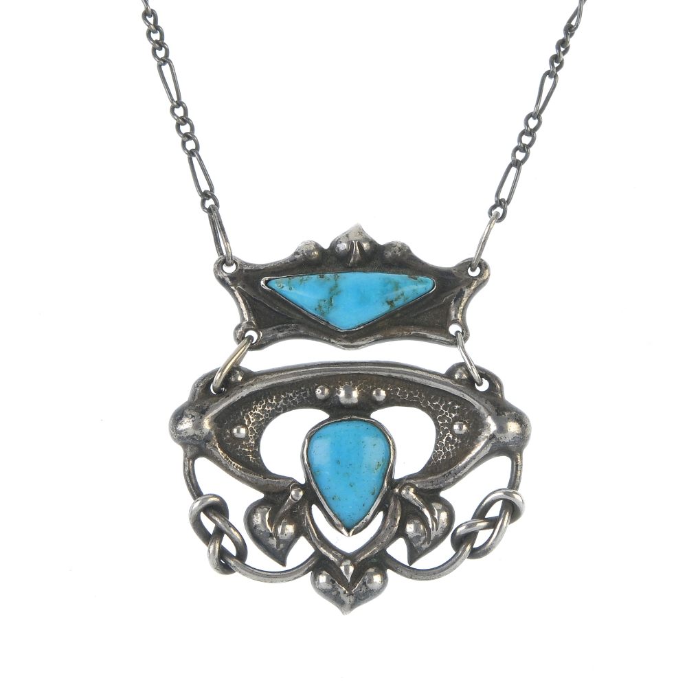 An early 20th century silver and turquoise pendant. The two panels of abstract foliate design, the