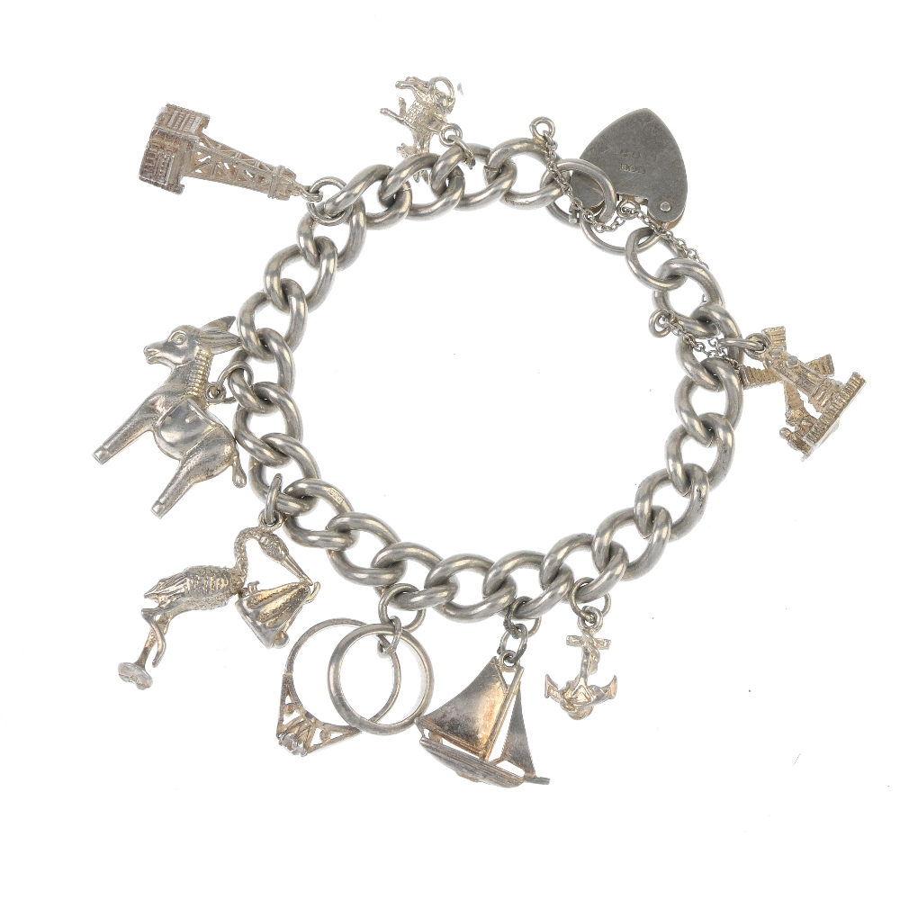 Two charm bracelets. The two curb-link chains suspending a total of fifteen charms including a