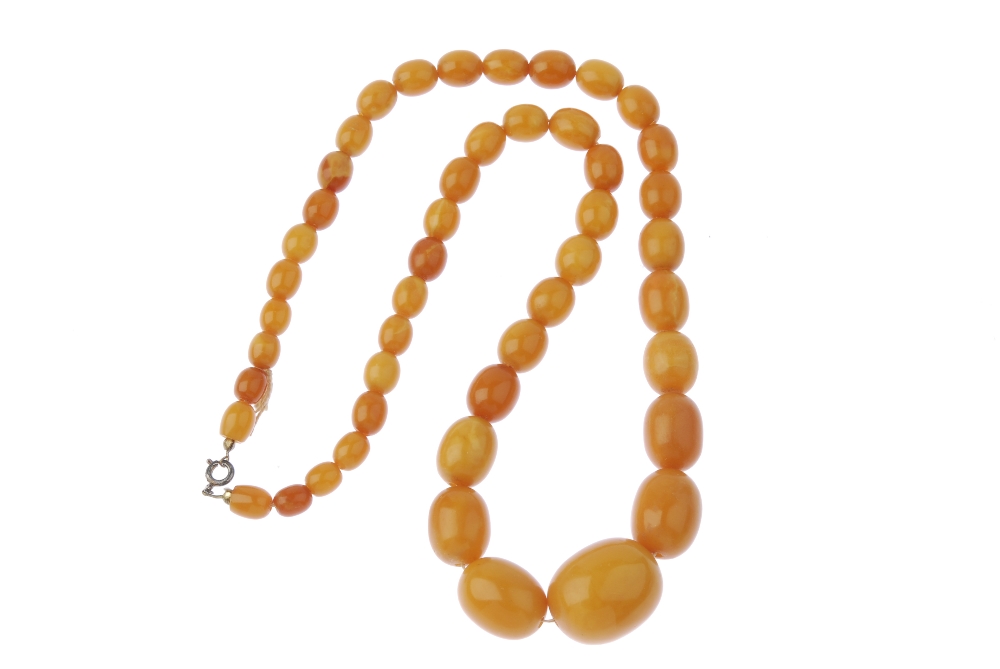 A natural amber bead necklace. Designed as a single row of forty-nine graduated oval-shape natural - Image 2 of 2