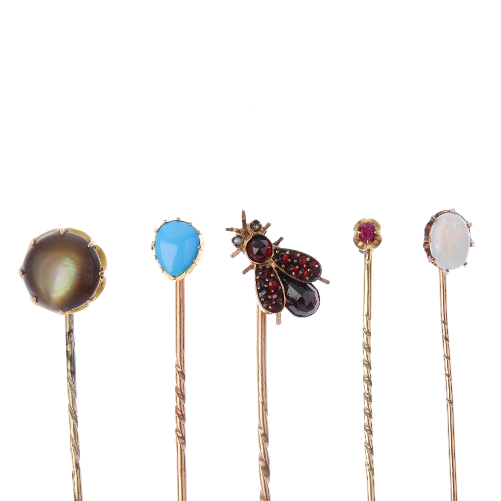 Five late 19th to early 20th century gem-set stickpins. To include a garnet and split pearl fly