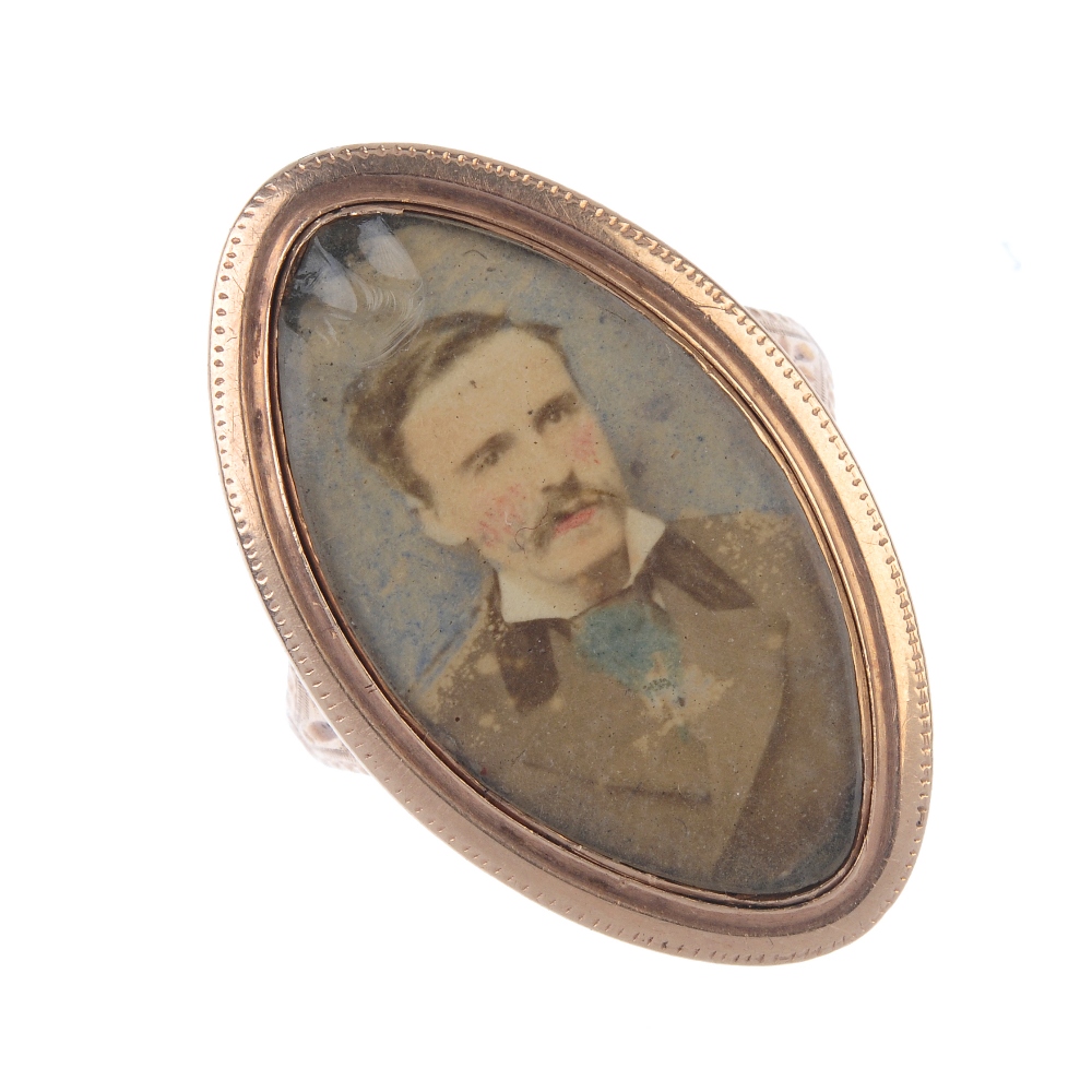 A late Georgian gold memorial ring with later added miniature portrait. Of marquise-shape outline,