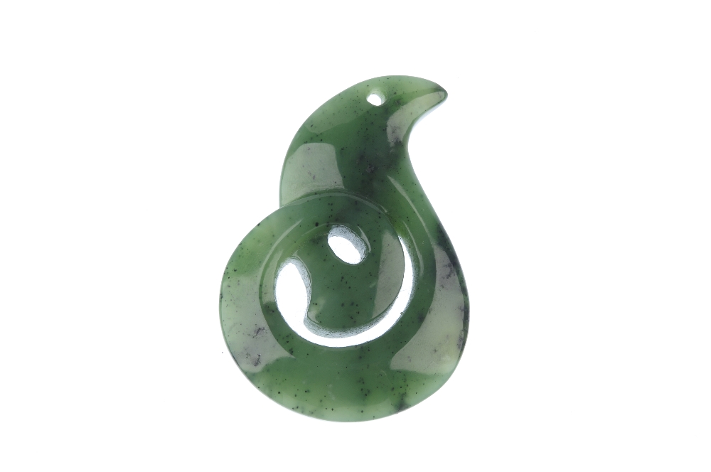 A carved Maori jade koru pendant. The koru representing an unfurling fern leaf and symbolising new - Image 2 of 2