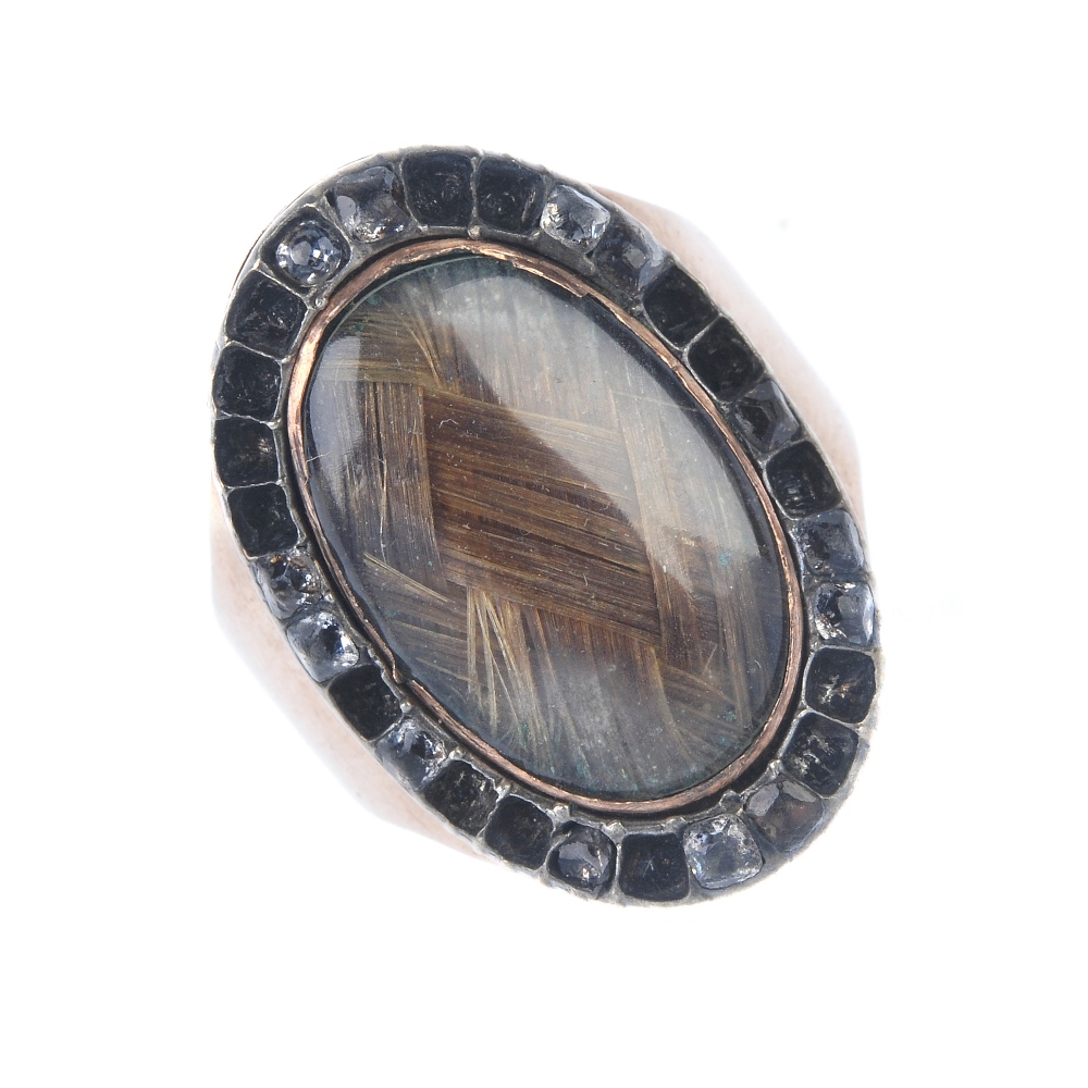 A George III gold and paste memorial ring. The woven hair panel, within a paste border, to the