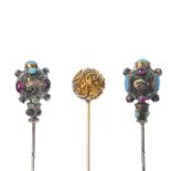 Three late 19th century hatpins. To include two similarly designed foil-back garnet, turquoise and