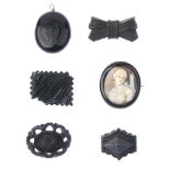 A selection of mainly late 19th century jet jewellery. To include a jet and shell cameo brooch,