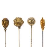 A selection of four mid to late 19th century stickpins. To include a scroll engraved stylised knot