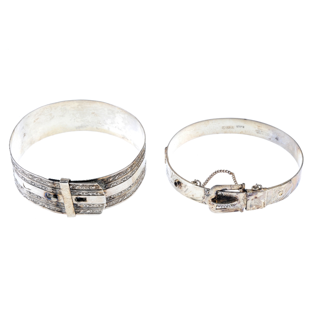 A selection of silver and white metal bangles. To include a scroll engraved cuff, a 1950s silver