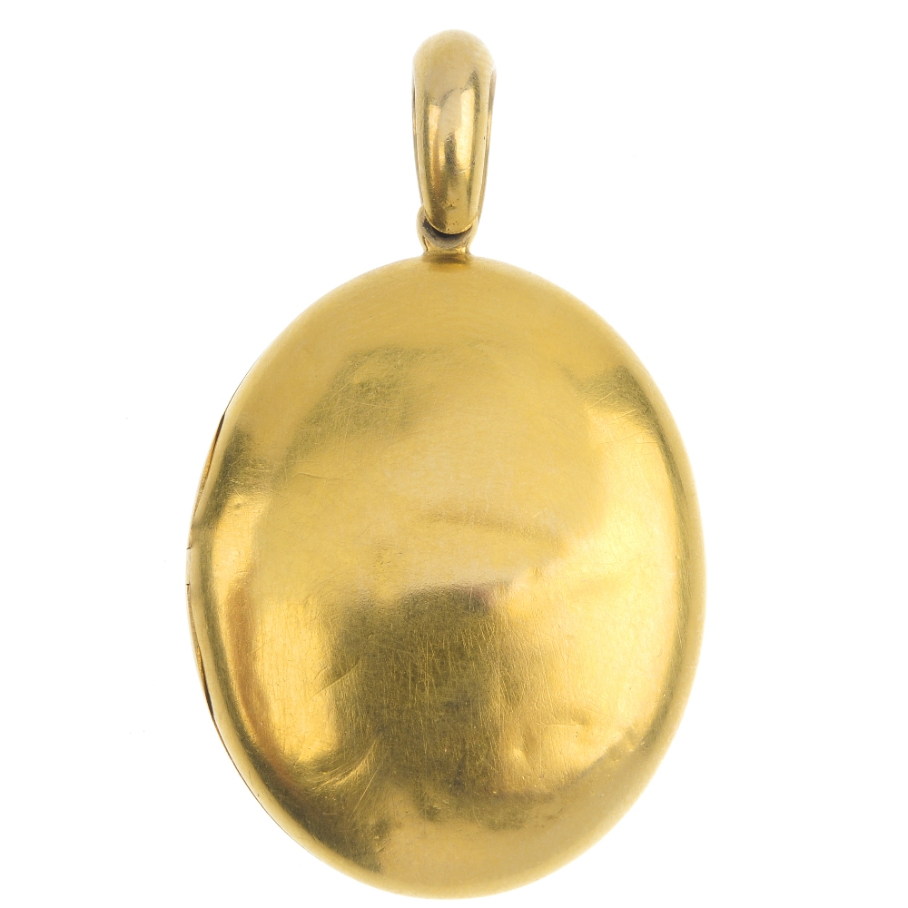 A mid Victorian 18ct gold locket, circa 1870. The oval-shape locket, suspended from a tapered