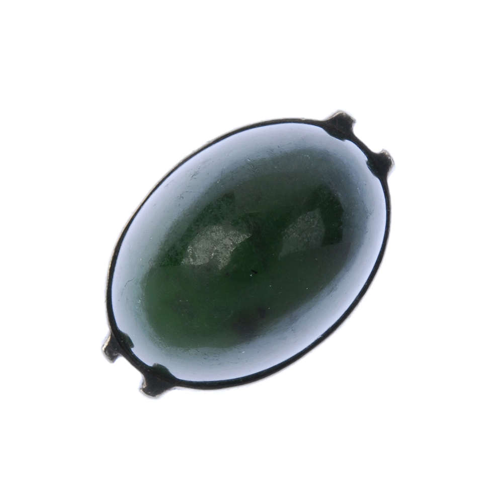 ANDREAS MIKKELSEN - a ring. Designed as an oval-shape nephrite jade cabochon, collet-set to the