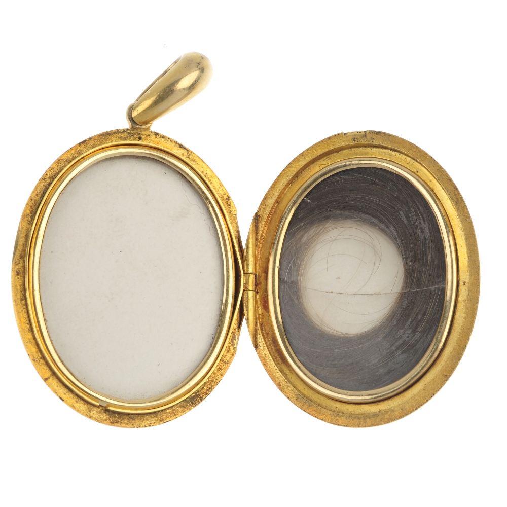 A mid Victorian 18ct gold locket, circa 1870. The oval-shape locket, suspended from a tapered - Image 2 of 2