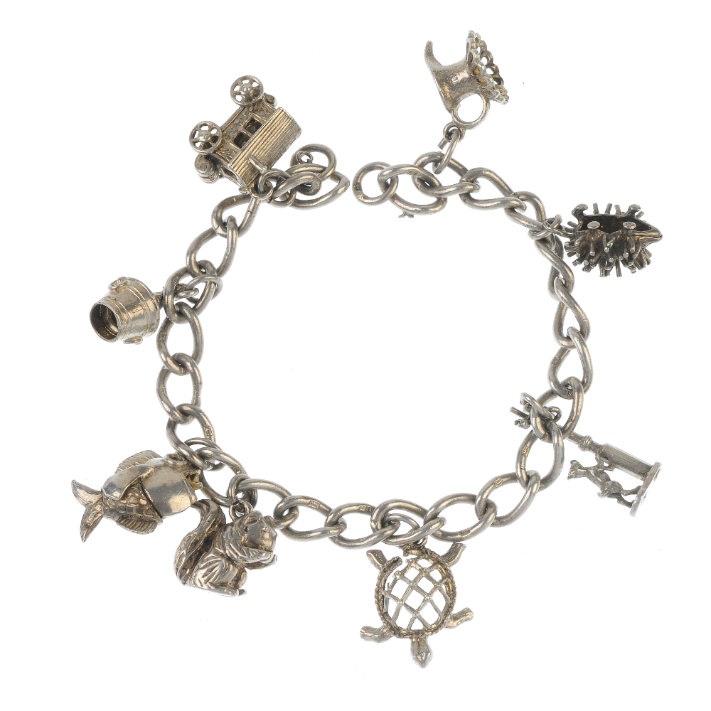 Two charm bracelets. Both designed as curb-link chains, suspending a total of fourteen charms, to