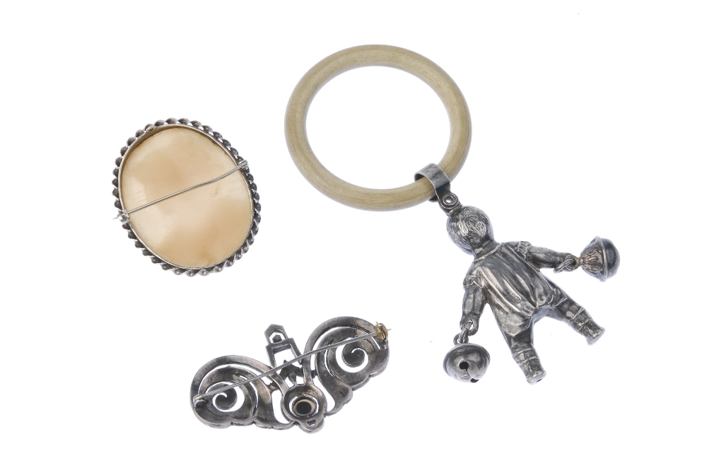 A selection of silver items. To include a child's rattle, designed as a baby carrying a bell in - Image 2 of 3