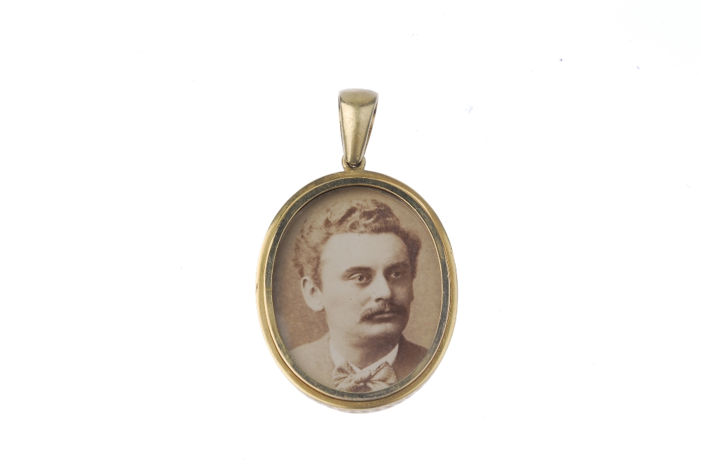 A late 19th century gold photograph pendant. The oval-shape floral and foliate engraved pendant, - Image 2 of 2