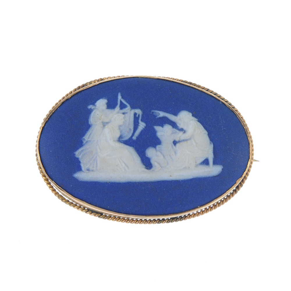 A 9ct gold cameo ring and a Wedgwood brooch. The ring designed as an oval-shape carving depicting