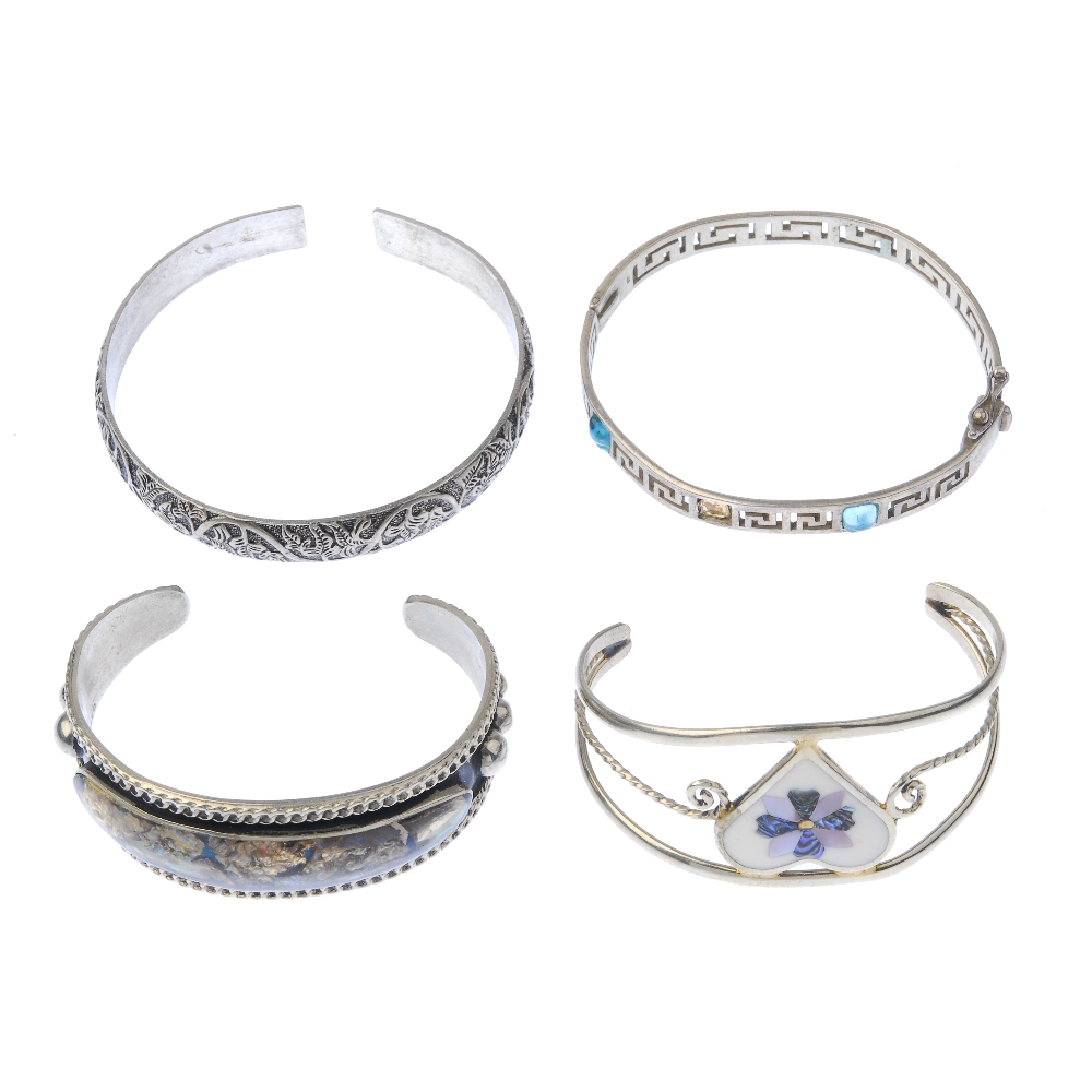 A selection of silver and white metal bangles. To include a broad hinged silver bangle, with